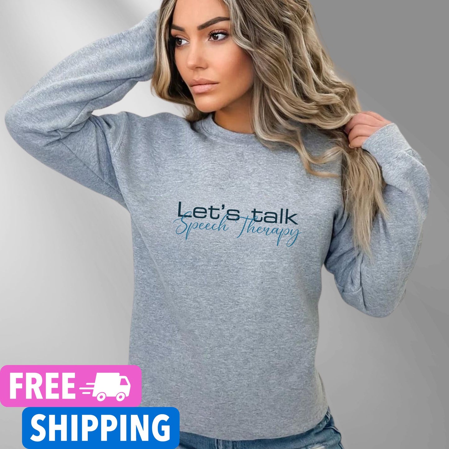 Person wearing a Sports Grey Let's Talk Speech Therapy statement clothing crew neck sweatshirt with blue and black text, standing in an outdoor forest setting. Premium DTG print quality, fast delivery, and free worldwide shipping by Yebber.