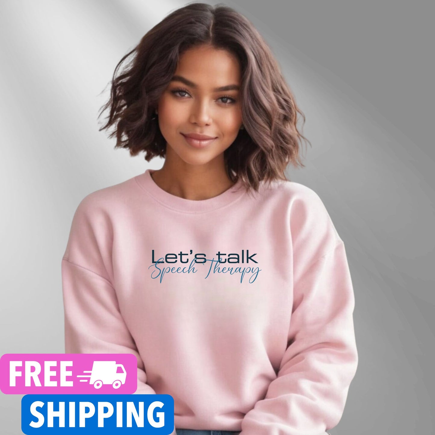 Person wearing a pink Let's Talk Speech Therapy statement clothing crew neck sweatshirt with blue and black text, standing in an outdoor forest setting. Premium DTG print quality, fast delivery, and free worldwide shipping by Yebber.