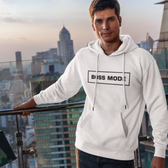 A man wearing a white BOSS MODE hoodie standing on a rooftop with a city skyline in the background.
