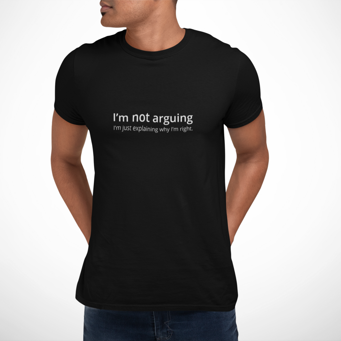 Person wearing a black Just Explaining T-shirt from Yebber, featuring bold typography that reflects a sharp, sarcastic mindset – statement clothing for witty individuals.