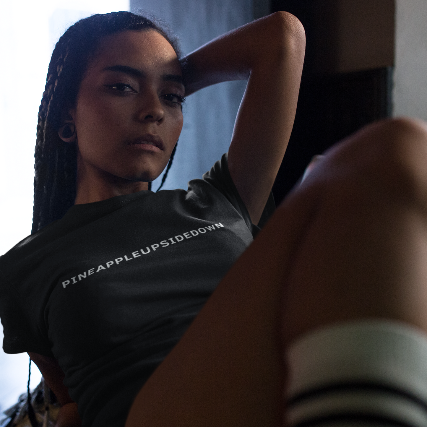 Woman wearing a Pineapple Upside Down T-shirt from Yebber, featuring a bold upside-down pineapple graphic – statement clothing for those who know.