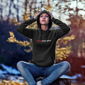 Person wearing a black Love Not War Hoodie from Yebber, featuring bold typography promoting peace – statement clothing for advocates of harmony.