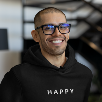Person wearing a black Happy Hoodie from Yebber, featuring minimalist embroidery on a soft, eco-friendly fabric – statement clothing for those who spread good vibes.