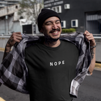 Person wearing a Nope T-shirt from Yebber, featuring bold minimalist text on a premium cotton tee – statement clothing for those who stand their ground.