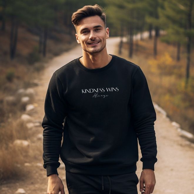 Lifestyle image of a person wearing the "Kindness Wins, Always" sweatshirt, showcasing its stylish fit and inspirational message.