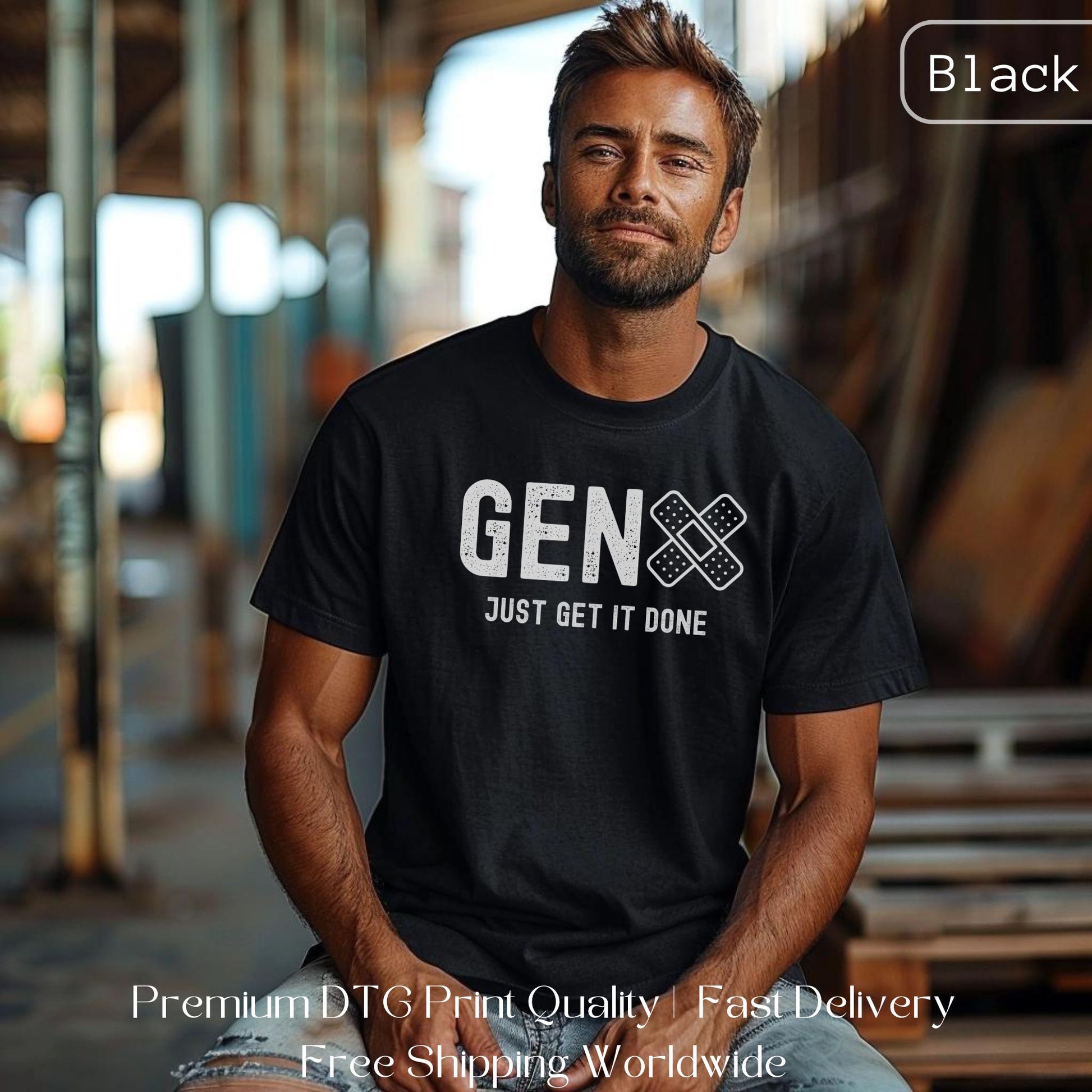 Man wearing a black Gen X statement clothing T-shirt with the text "Just Get It Done," standing in an industrial setting. Premium DTG print quality, fast delivery, and free worldwide shipping by Yebber.