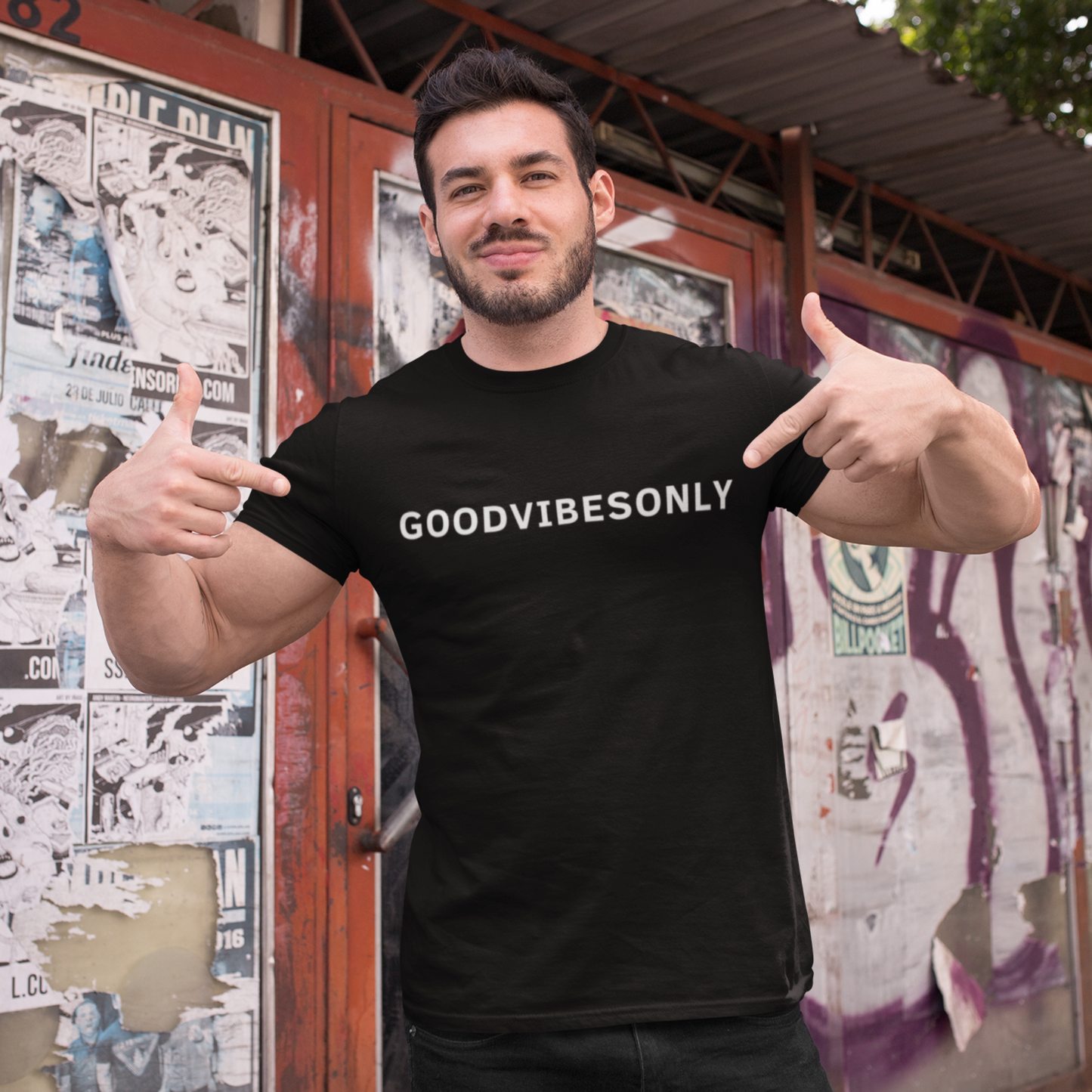 Person wearing a black Good Vibes Only T-shirt from Yebber, featuring bold typography that promotes positivity – statement clothing for those who embrace an optimistic mindset.