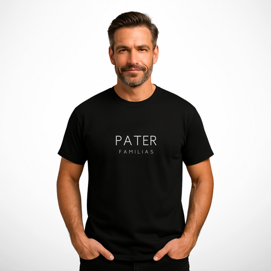 Middle-aged man confidently wearing a black "PATER FAMILIAS" statement T-shirt by Yebber, standing in a relaxed pose with a subtle smile, showcasing the bold white typography against the premium cotton fabric – ideal for Father's Day and modern family leaders.