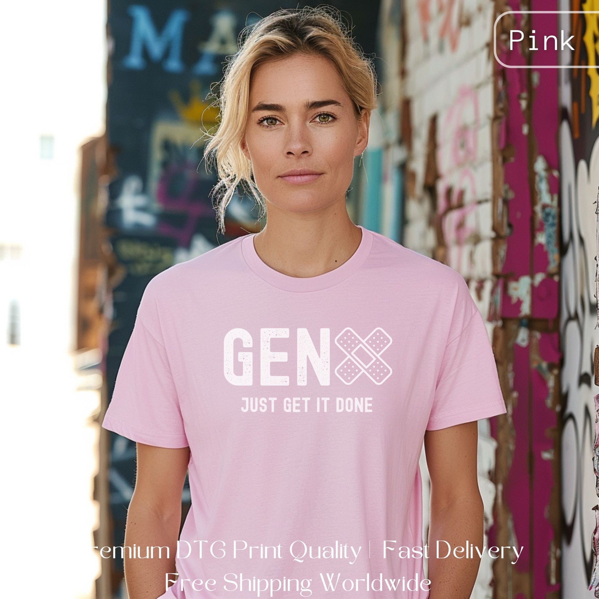 Woman wearing a pink Gen X statement clothing T-shirt with the text "Just Get It Done," standing in an industrial setting. Premium DTG print quality, fast delivery, and free worldwide shipping by Yebber.