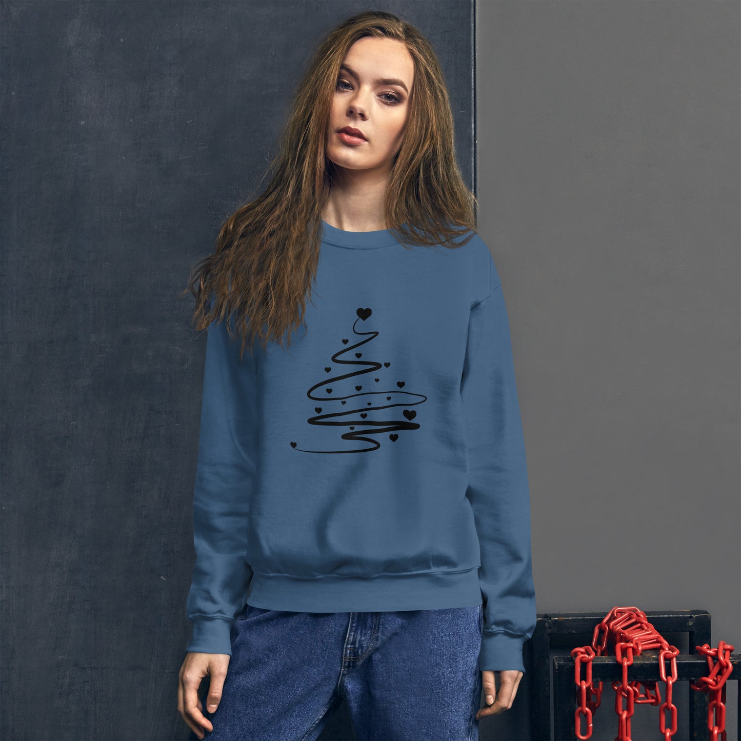 Person wearing a Indigo Blue Minimalistic Christmas statement clothing sweatshirt with a black abstract Christmas tree design.