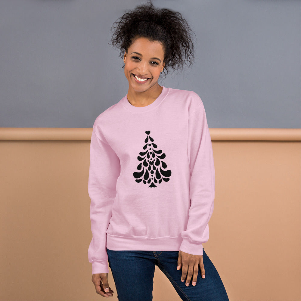 Person wearing a Light Pink Minimalistic Christmas statement clothing sweatshirt with a black minimalist Christmas tree design.