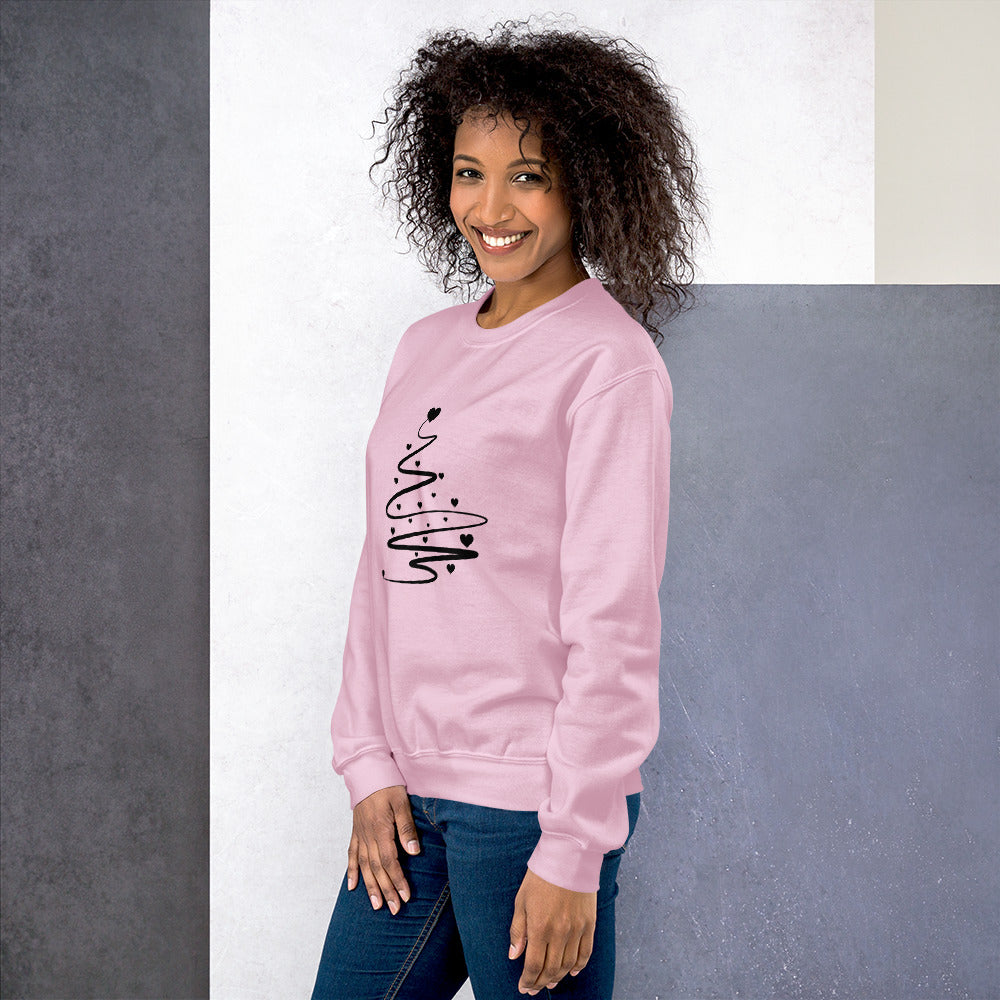 Person wearing a Light Pink Minimalistic Christmas statement clothing sweatshirt with a black abstract Christmas tree design.