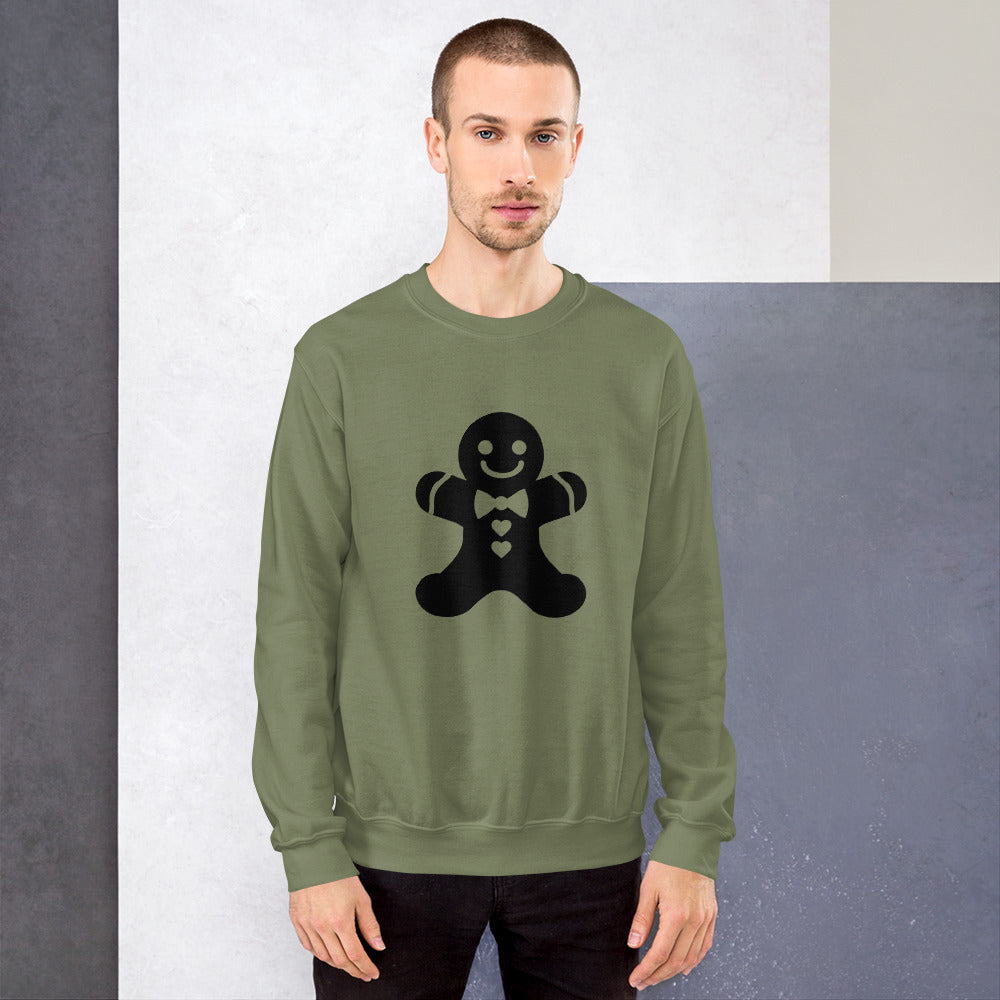 Person wearing a Military Green Minimalistic Christmas statement clothing sweatshirt with a black gingerbread man design.