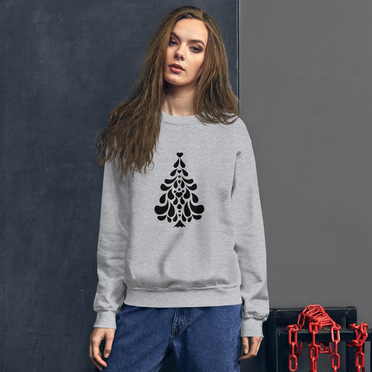 Person wearing a Sports Grey Minimalistic Christmas statement clothing sweatshirt with a black minimalist Christmas tree design.