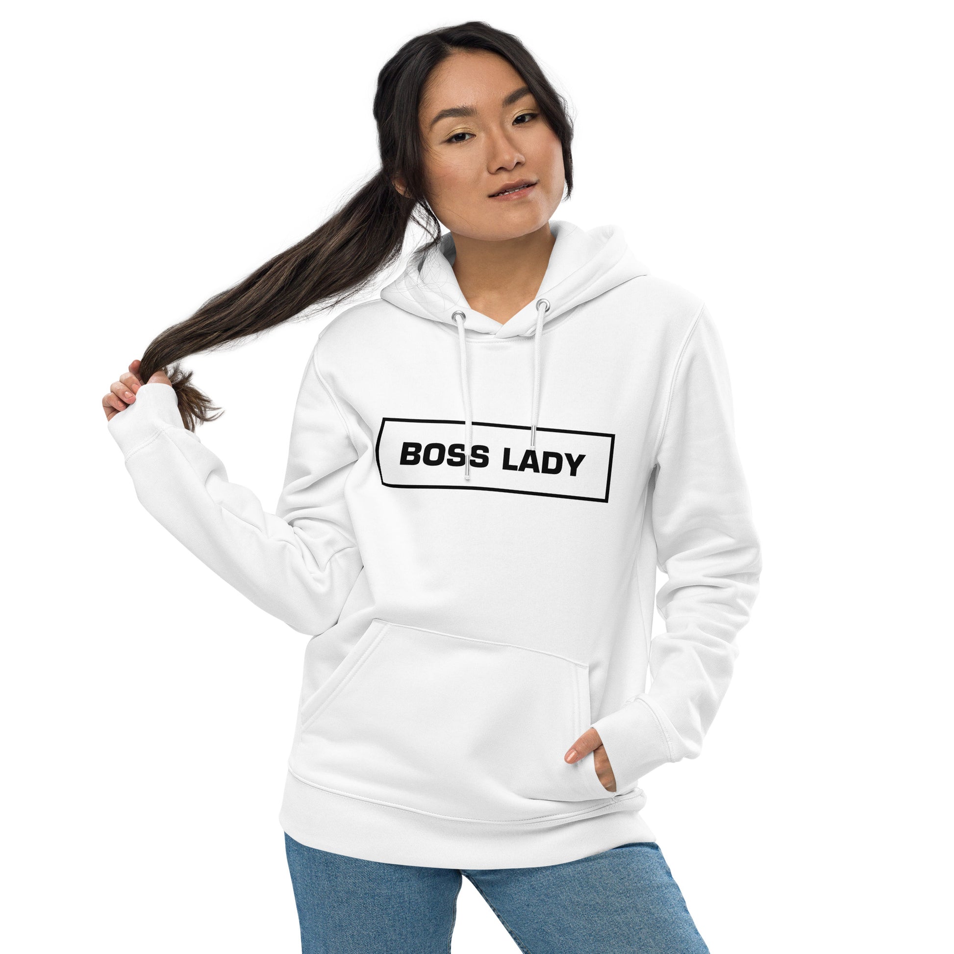 Woman wearing a white Boss Lady statement clothing hoodie with bold black text.