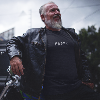 Person wearing a Happy T-shirt from Yebber, featuring a minimalist yet bold text design – statement clothing for those who embrace positivity.