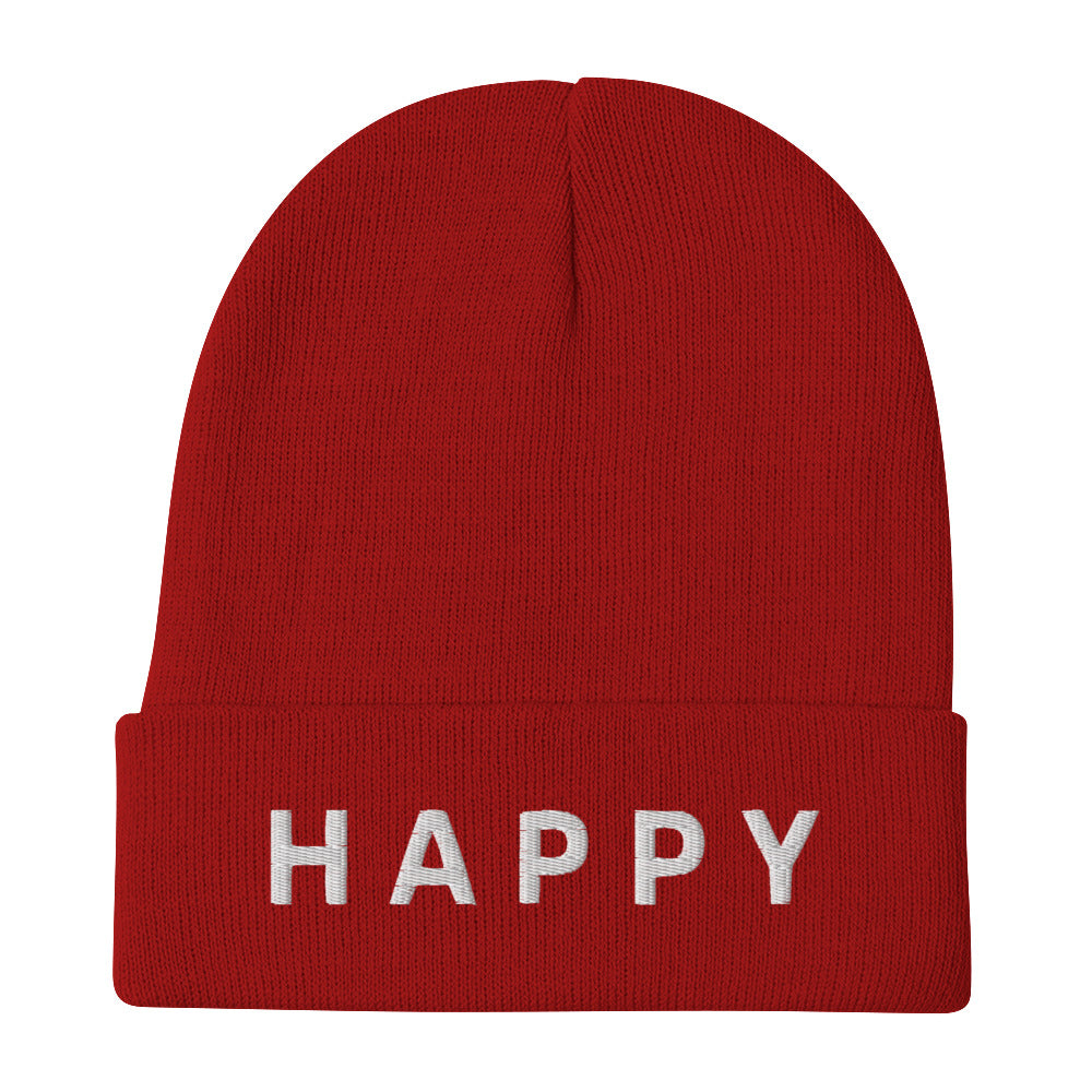 Close-up of a red Happy Embroidered Beanie from Yebber, featuring minimalist text embroidery on a cozy cotton-acrylic blend – statement clothing for positive thinkers.