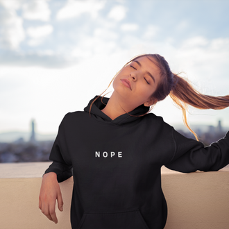 Woman wearing a Nope Hoodie from Yebber, featuring bold minimalist text on an eco-friendly hoodie – statement clothing for those who stand their ground.